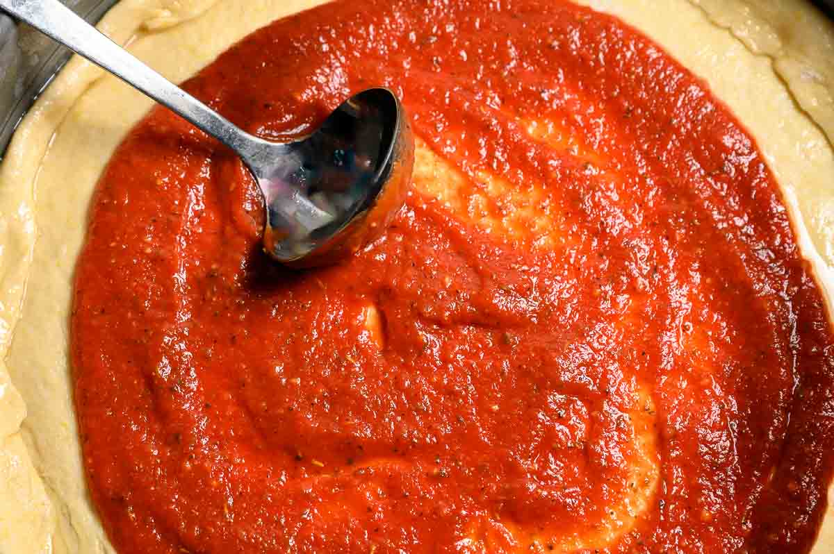 5 Minute Pizza Sauce spread on pizza dough.