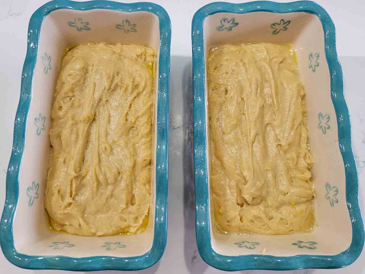 lemon loaf batter in two mini loaf pans.