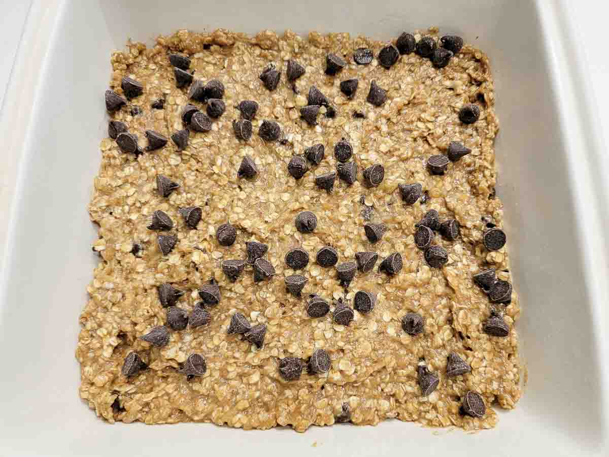 mashed banana, peanut butter, brown sugar, quick oats, cinnamon, baking powder, chocolate chips, and vanilla extract in a bowl.