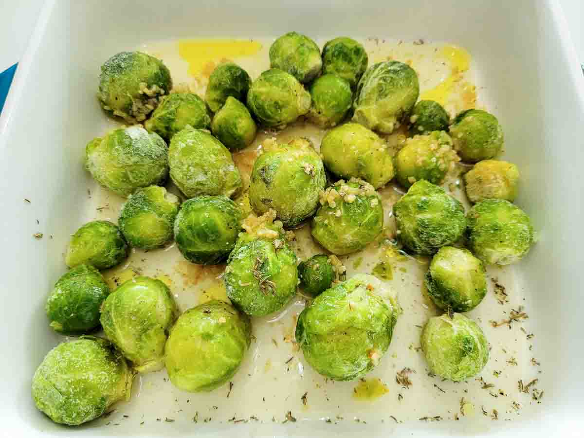 minced garlic, lemon juice, chicken broth, and thyme, brussels sprouts, and oil in a casserole dish.