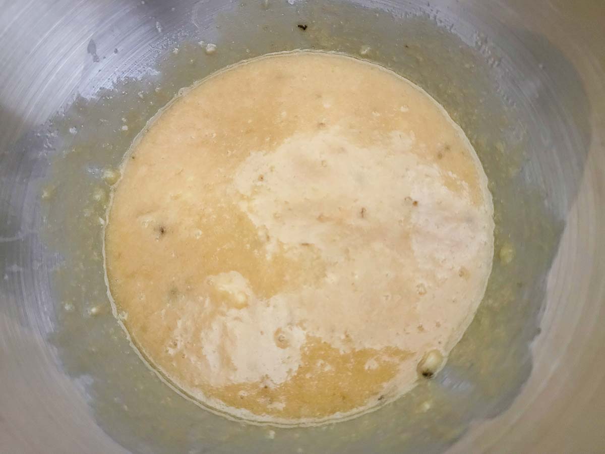 bananas mixed into batter in a bowl.