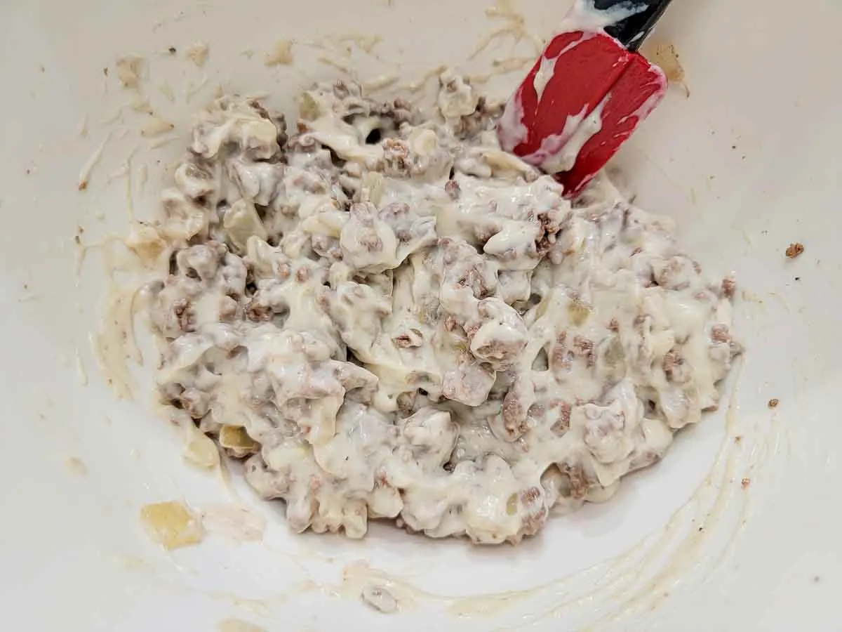 ground beef and cream of mushroom soup mixed in a bowl.