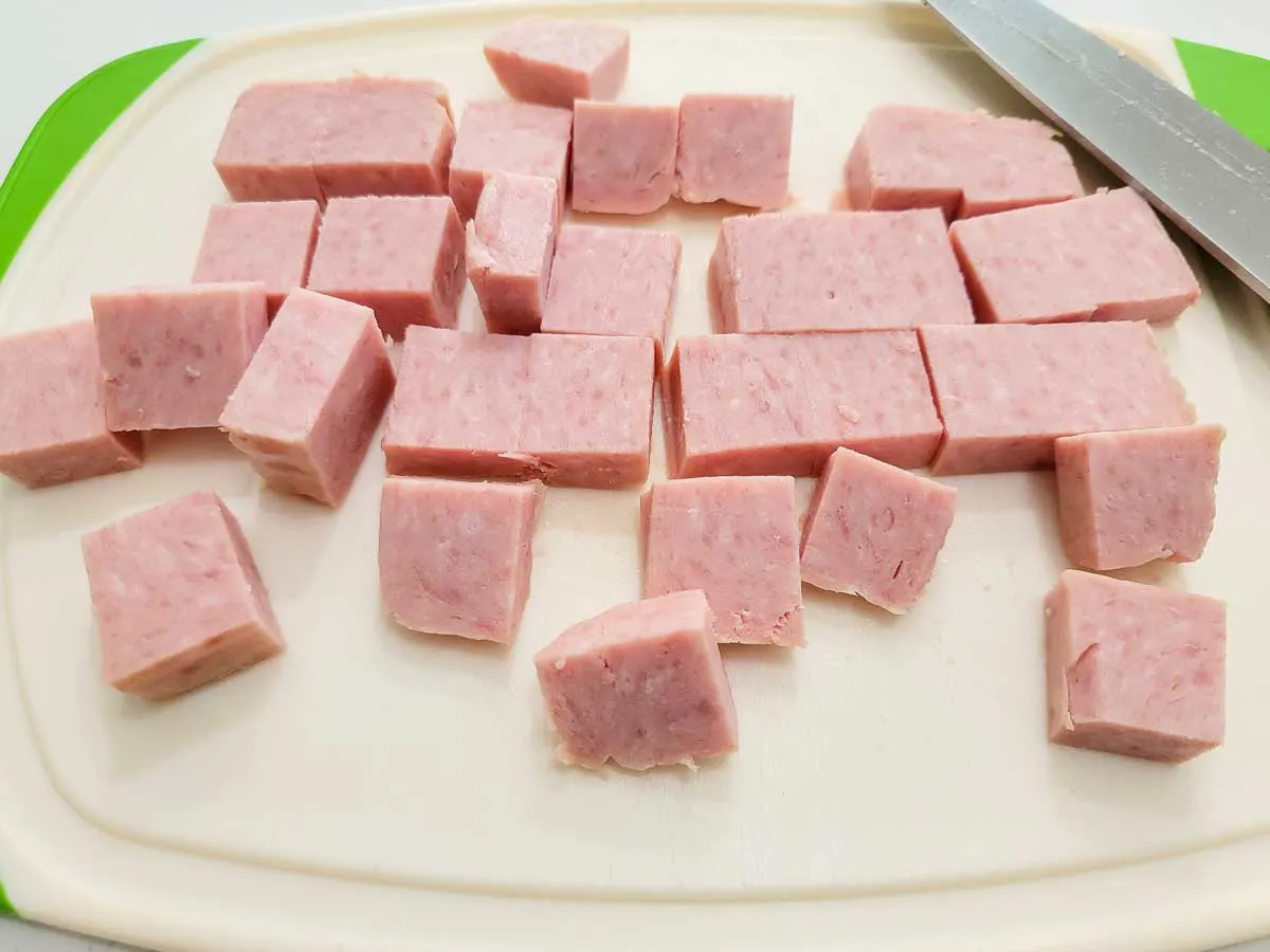 spam diced on a cutting board.