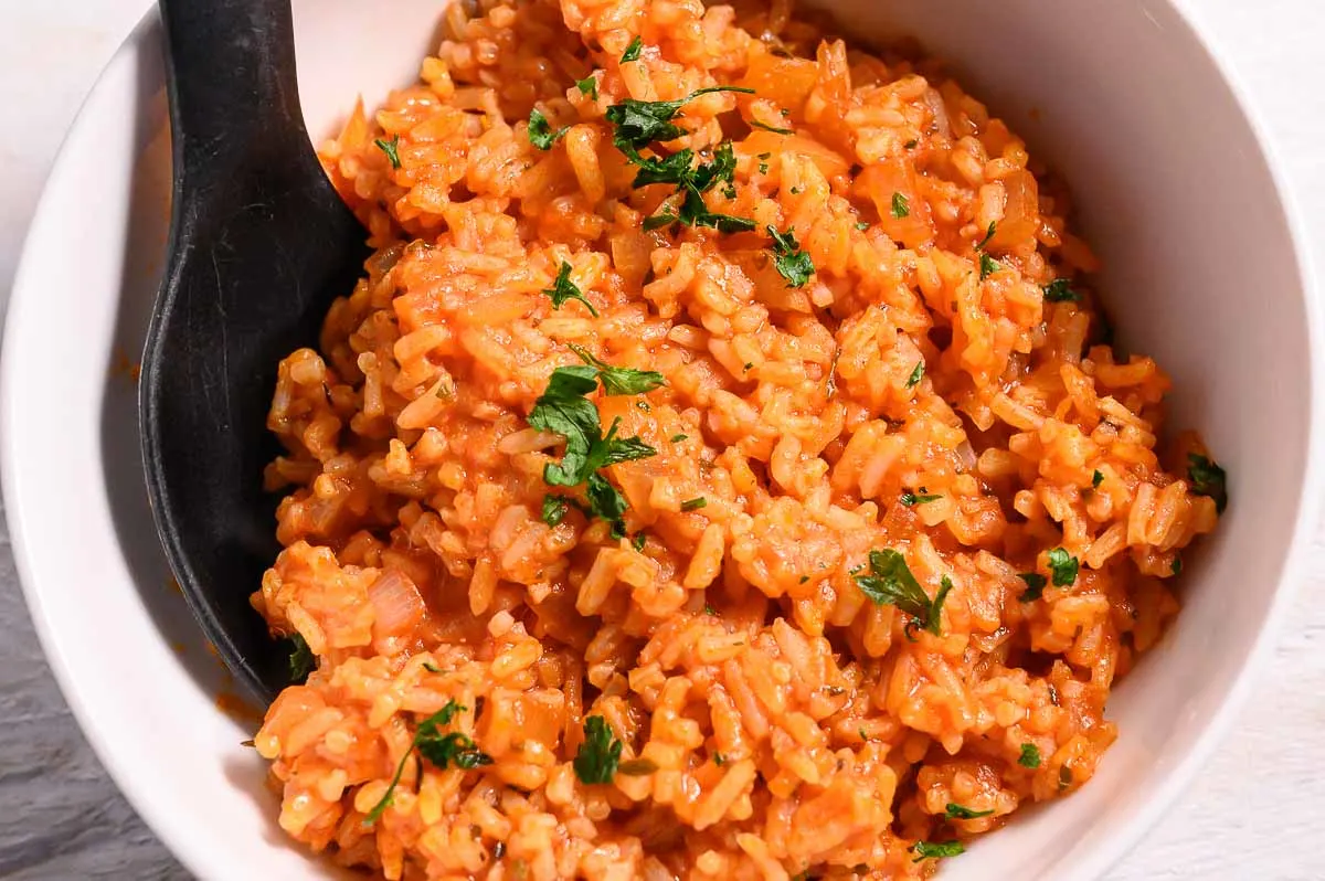 8 Ingredient Spanish Rice in a bowl with a spoon.