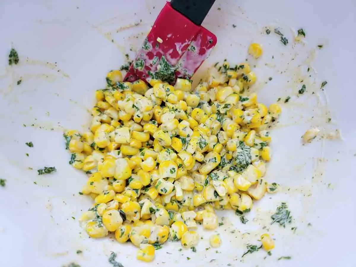 corn, mayo, cilantro, chili powder, lime juice, and table salt mixed in a bowl.