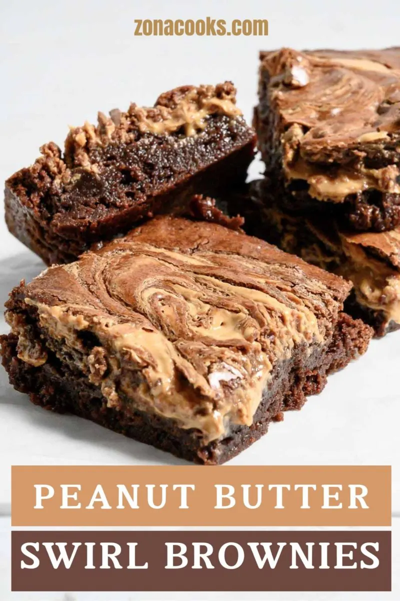 Peanut Butter Swirl Brownies stacked on parchment paper.