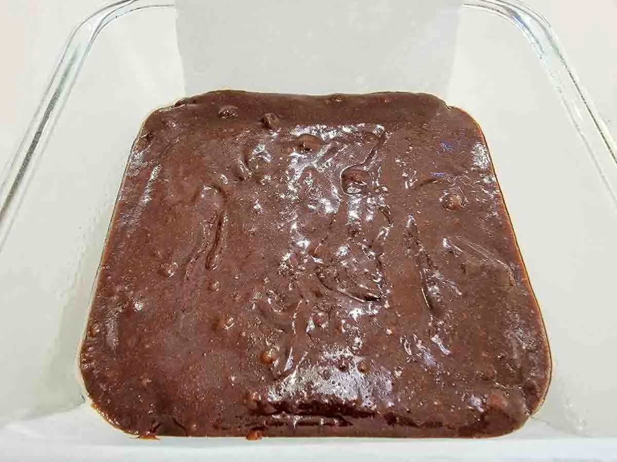 brownie batter in a square baking dish.