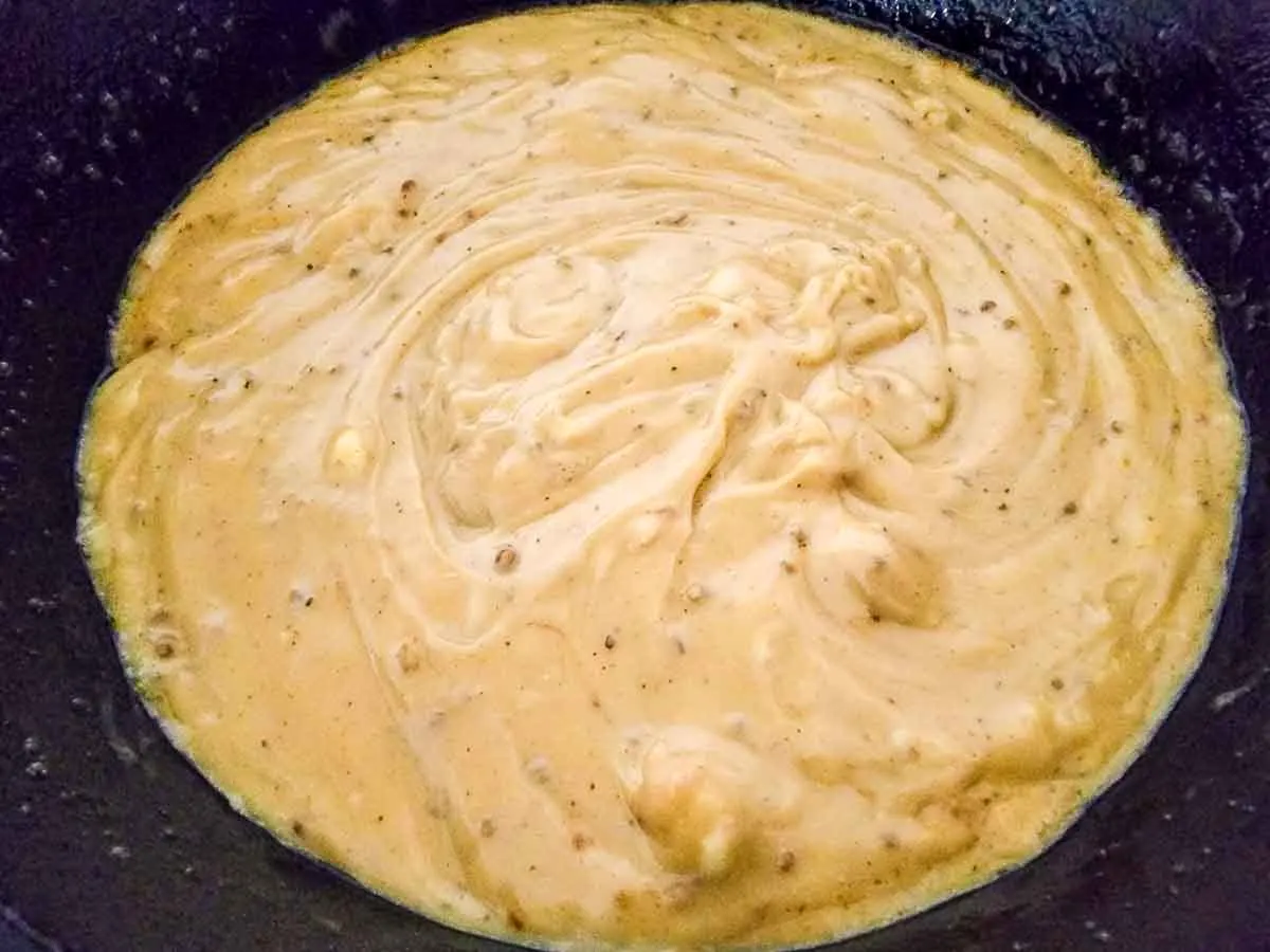 butter, garlic, and cream of chicken soup cooking in a pan.