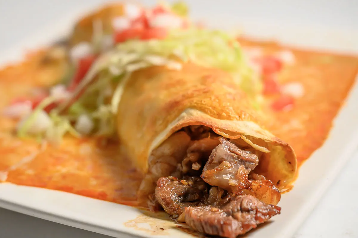 Ribeye Steak Wet Burrito on a plate.