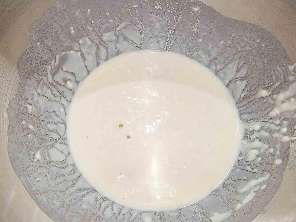 yeast, water, sugar, and flour in a large mixing bowl.