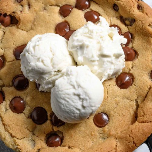 Mini Skillet Cookie topped with 3 scoops of vanilla ice cream.