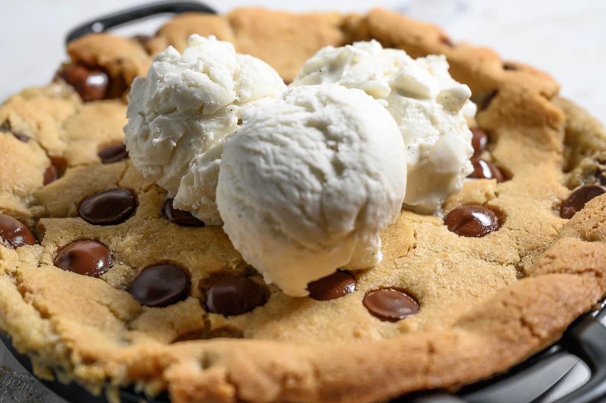 Mini Skillet Cookie topped with 3 scoops of vanilla ice cream.