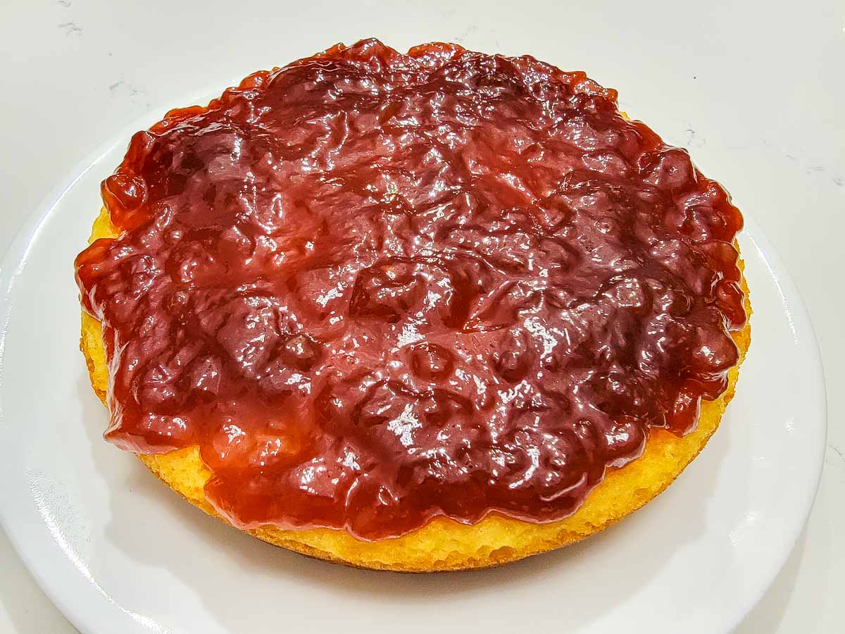 banana pudding and crushed pineapple cake topped with strawberry jam.