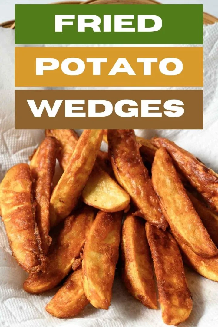 Battered Fried Potato Wedges on paper towel.