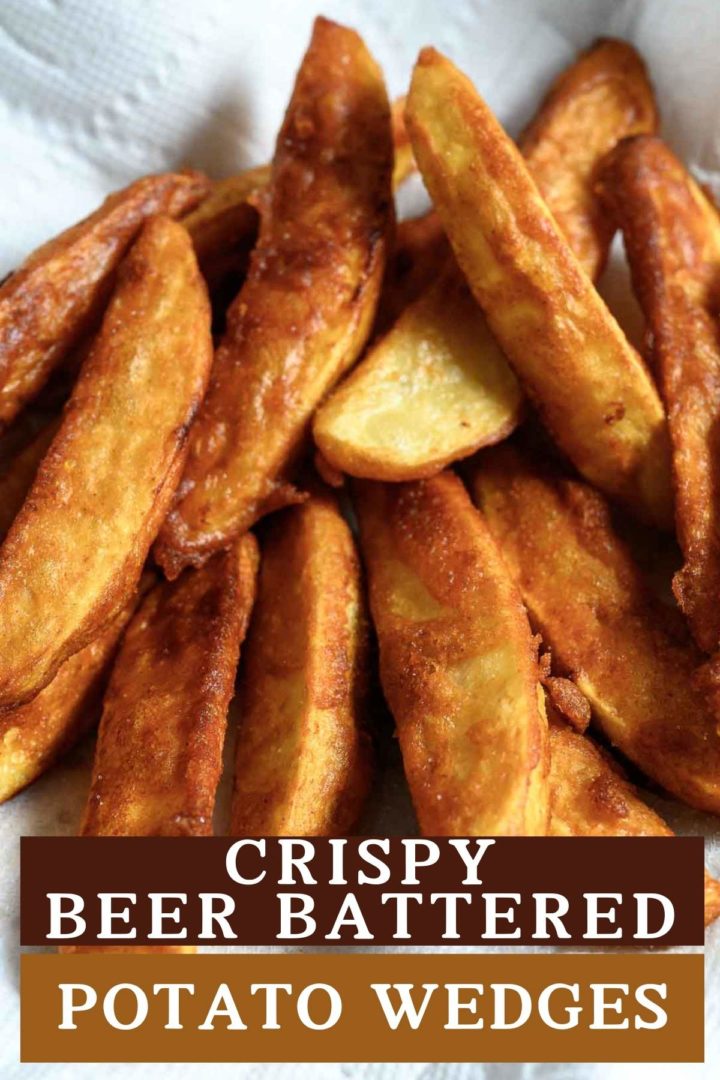 Crispy Beer Battered Potato Wedges on paper towel.