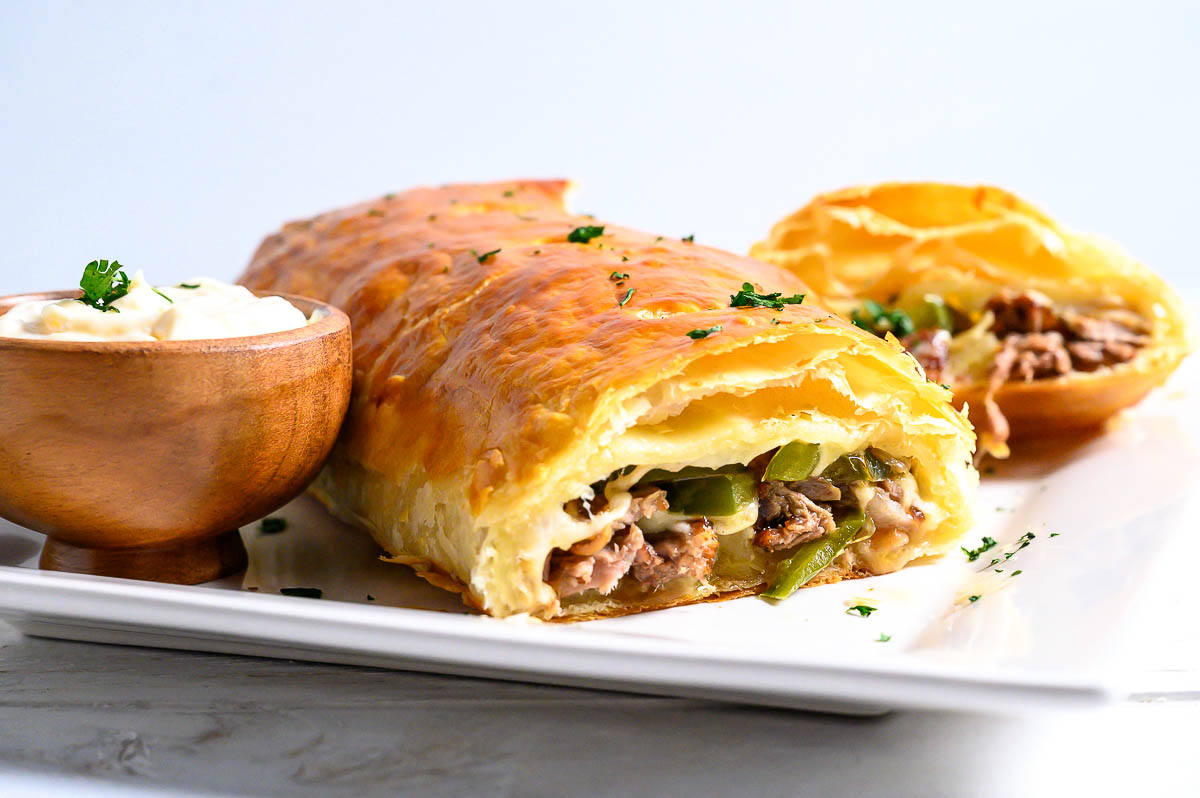 ribeye steak, green pepper, onions, and provolone cheese baked inside of flaky puff pastry.