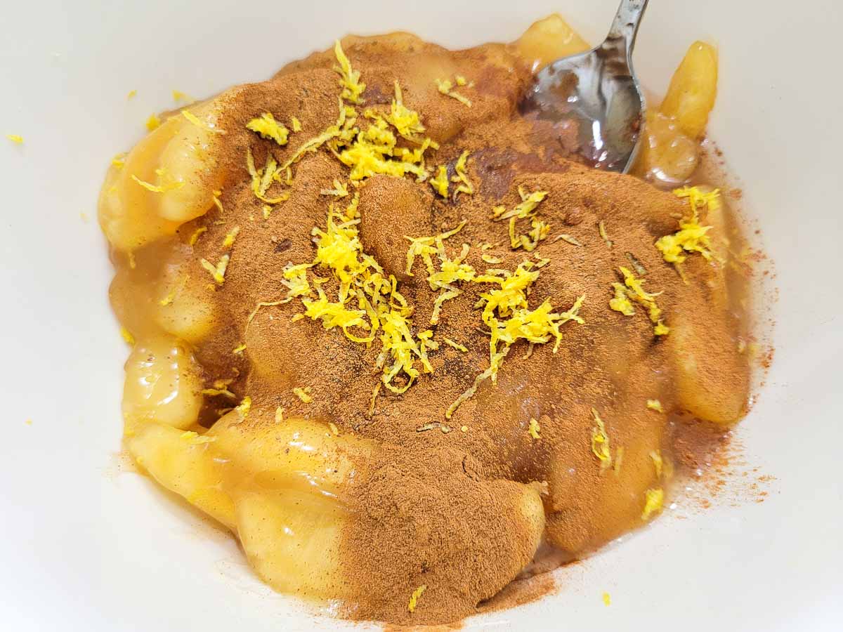 apple pie filling, cinnamon, nutmeg, lemon juice, and lemon zest in a mixing bowl.