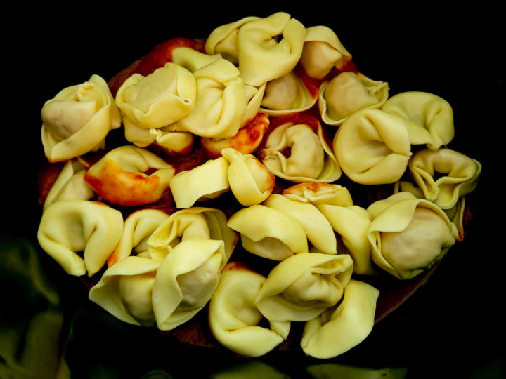 tortellini and spaghetti sauce in a crockpot.