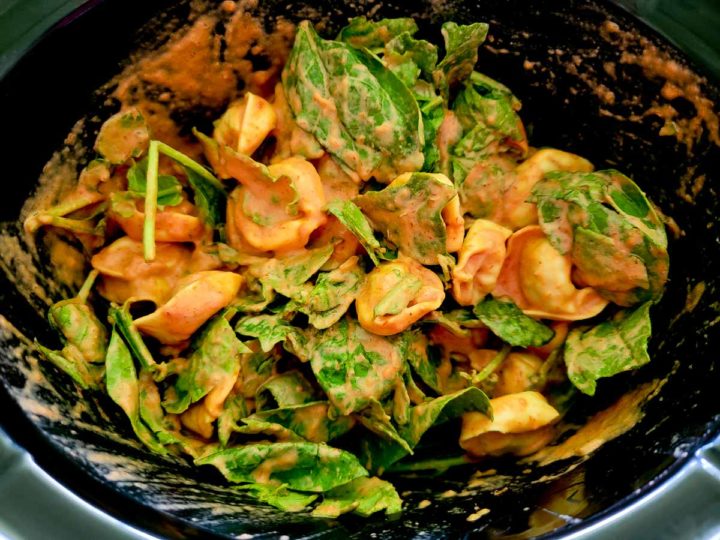 baby spinach, italian seasoning, tortellini, heavy cream, and spaghetti sauce in a crockpot.