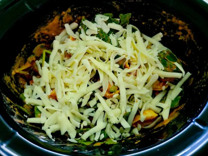 mozzarella cheese, baby spinach, italian seasoning, tortellini, heavy cream, and spaghetti sauce in a crockpot.