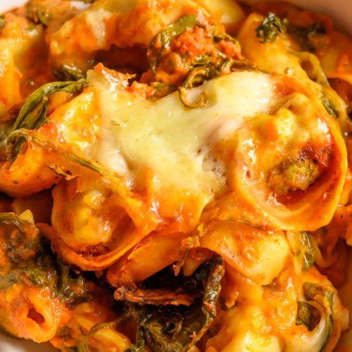 Crockpot Tortellini with spinach in a serving bowl.