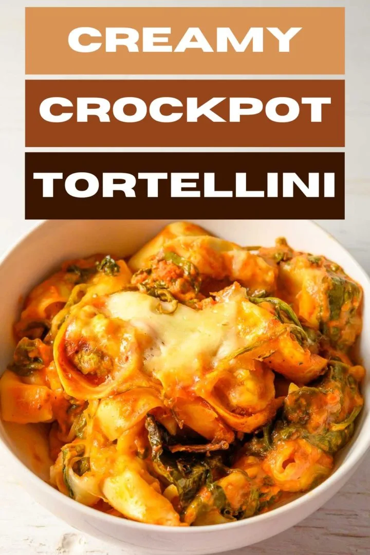 Creamy Crockpot Tortellini with spinach in a bowl.
