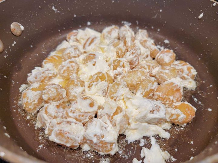 potato gnocchi and cream cheese frying in butter.