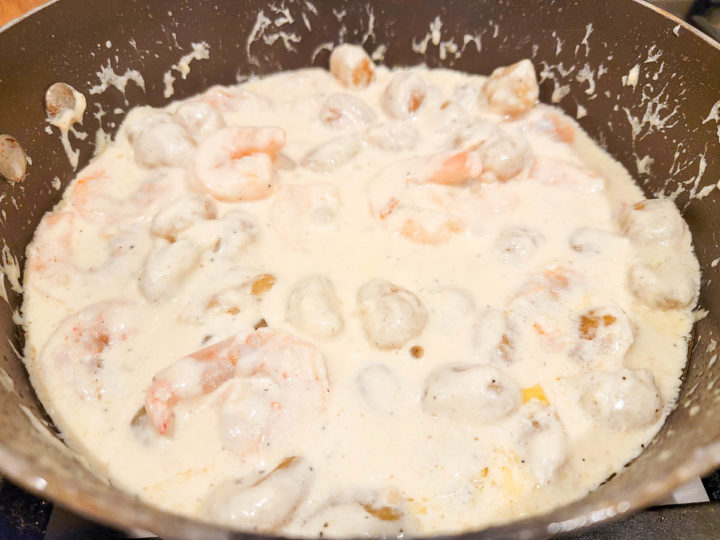 shrimp and potato gnocchi cooking in a cream sauce.