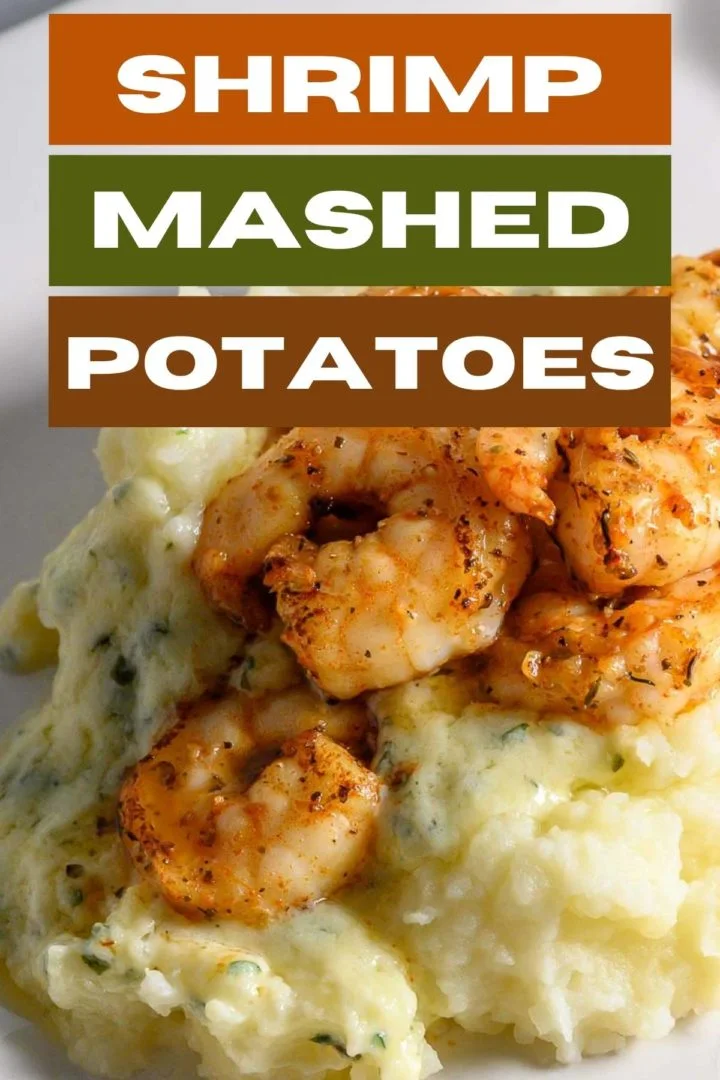 Shrimp and Mashed Potatoes with a thick, creamy basil and parmesan cheese sauce on a plate.