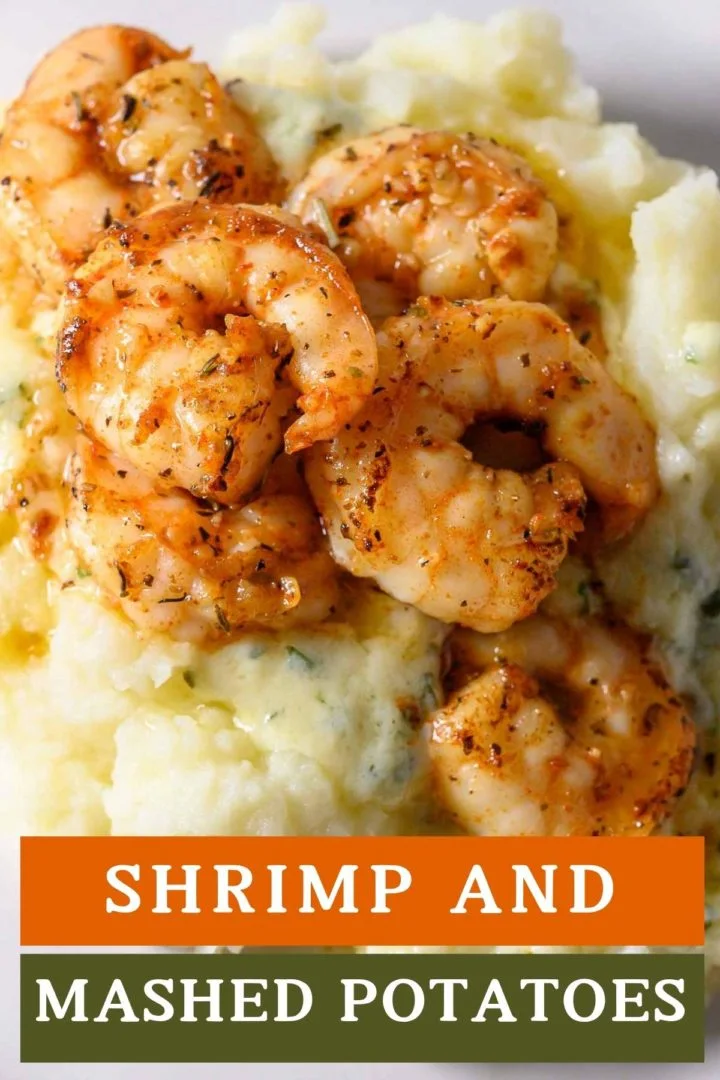 Shrimp and Mashed Potatoes with a thick, creamy basil and parmesan cheese sauce on a plate.