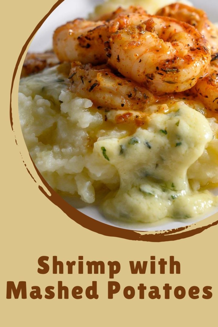 Shrimp and Mashed Potatoes with a thick, creamy basil and parmesan cheese sauce on a plate.