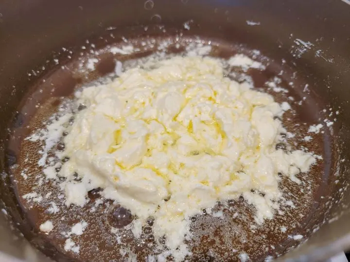 butter and cream cheese r cooking in a pan.