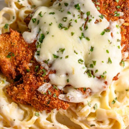 crispy panko fried chicken over pasta and topped with melted cheese.