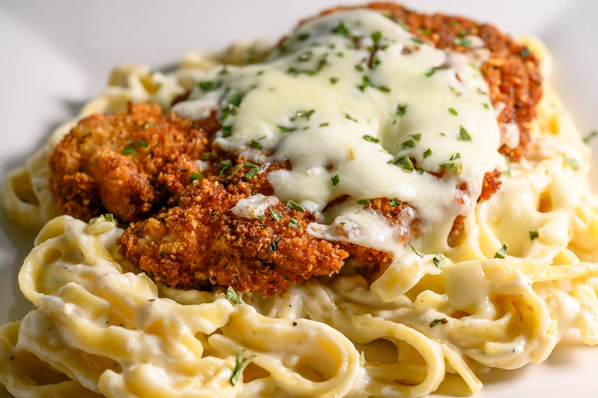 crispy panko fried chicken over pasta and topped with melted cheese.