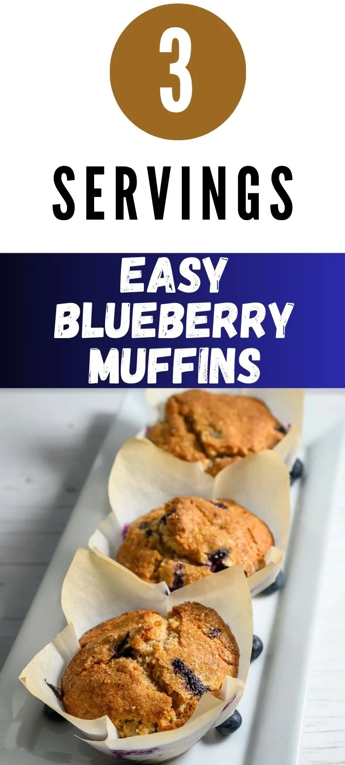 three jumbo blueberry muffins in paper liners on a platter.