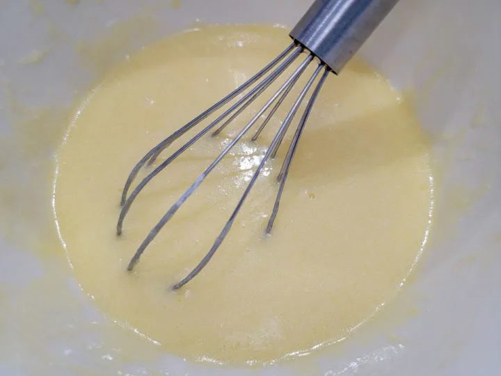 sugar, egg, oil, melted butter, sour cream, whole milk, and vanilla whisked in a bowl.