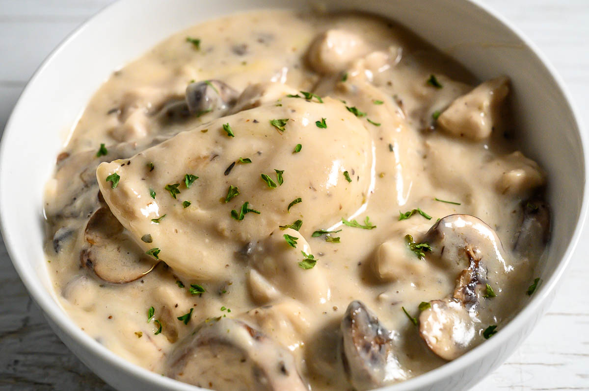 baked pierogi, chicken, mushrooms, and creamy sauce in a serving bowl.