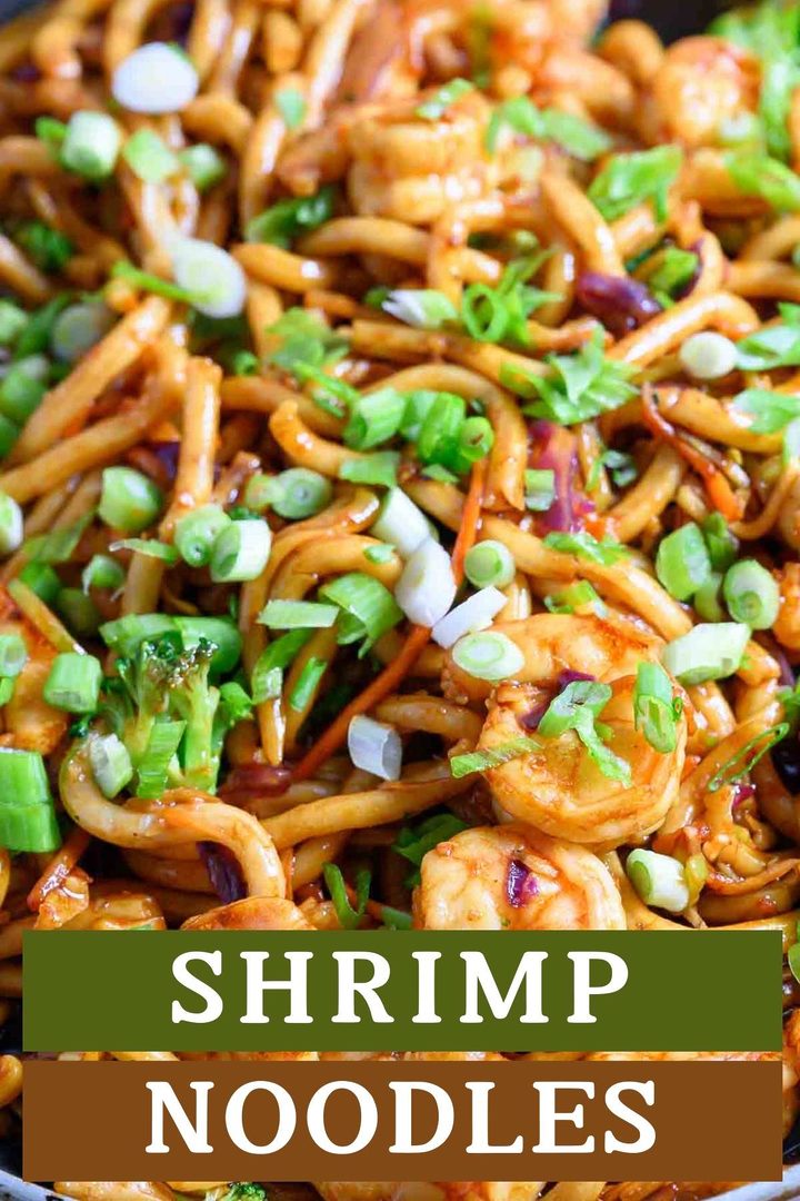 chewy udon noodles, tender shrimp, broccoli slaw, and stir fry sauce in a frying pan.