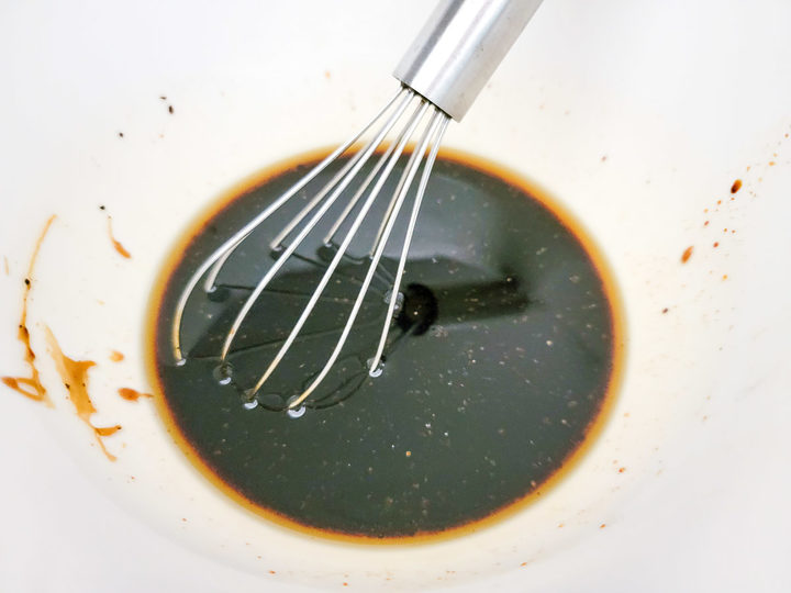 oyster sauce, dark soy sauce, rice vinegar, brown sugar, black pepper, and toasted sesame oil whisked in a bowl.