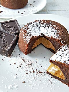 two peanut butter chocolate lava cakes on two plates.