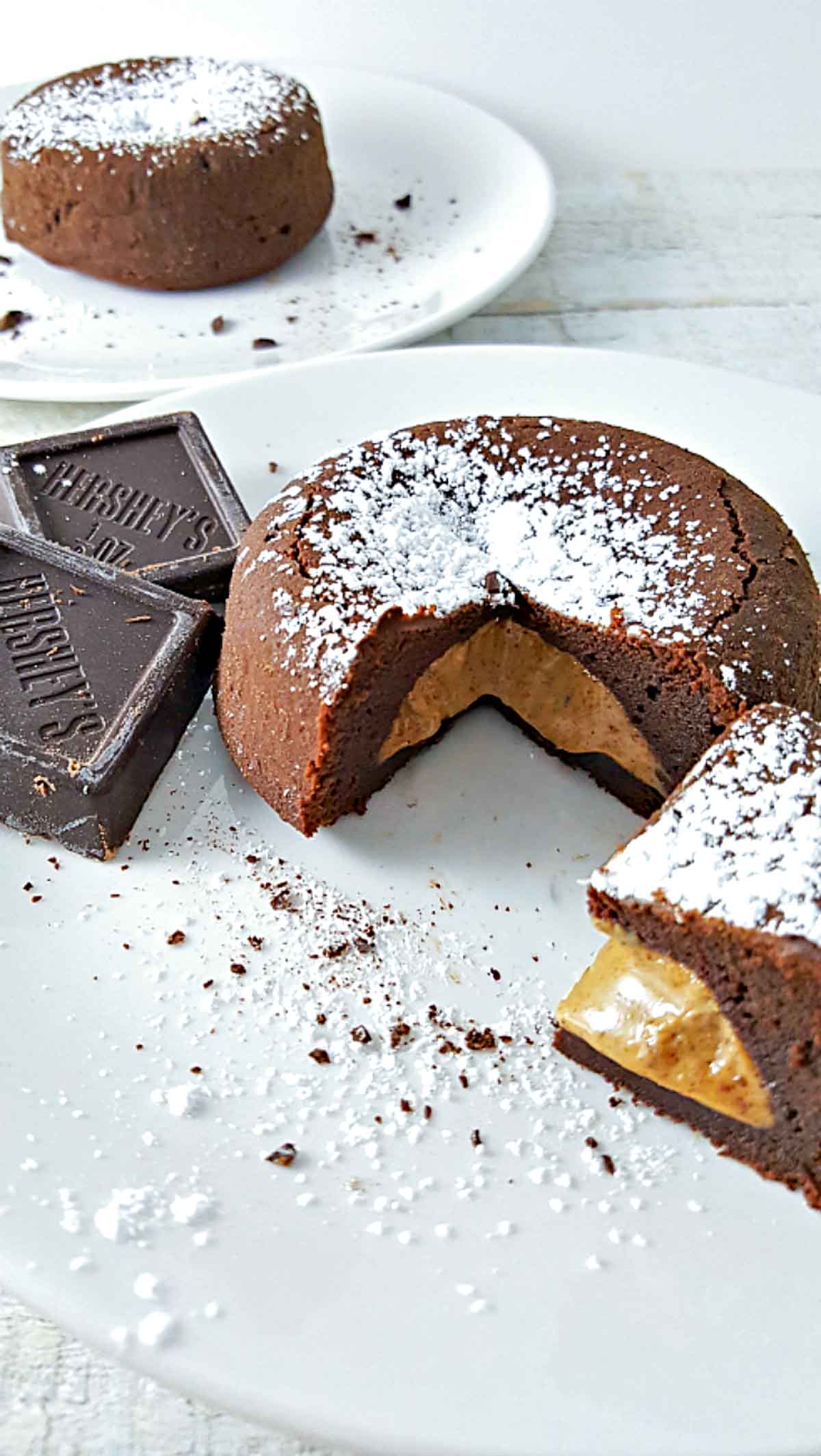 two peanut butter chocolate lava cakes on two plates.