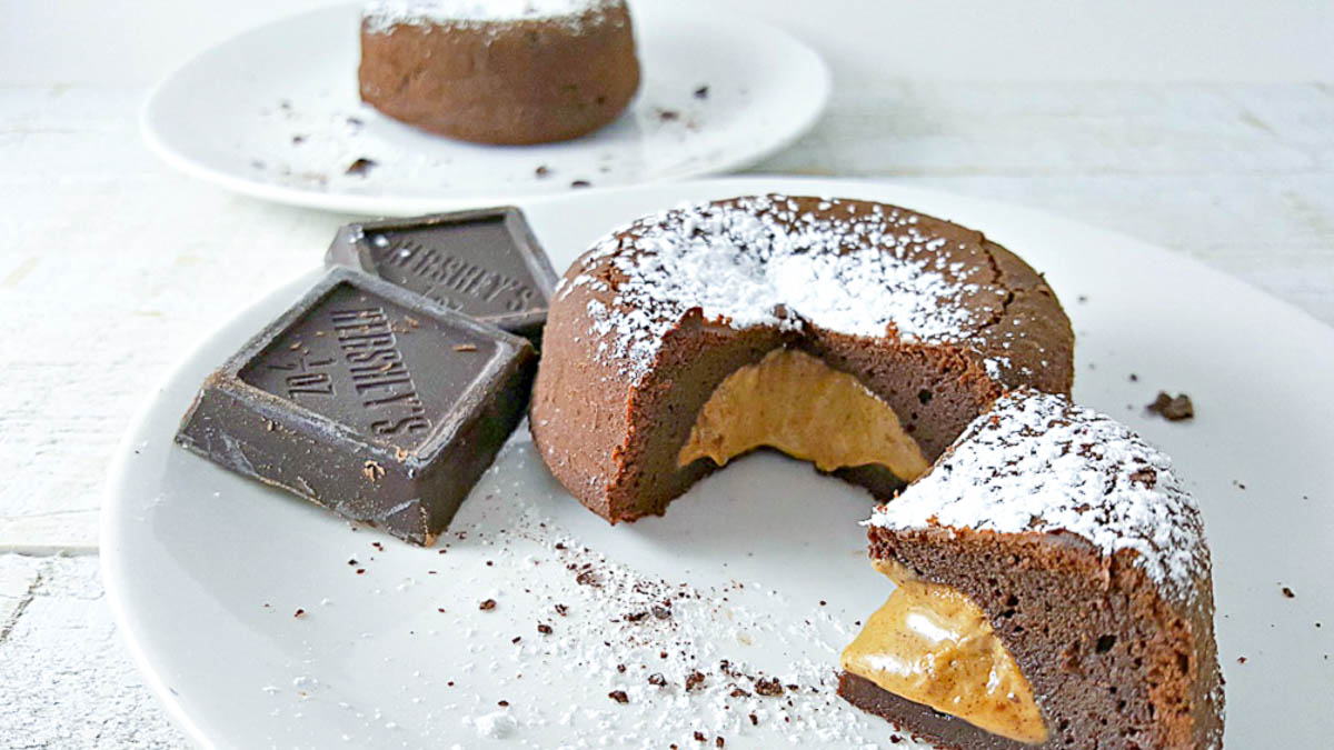 two peanut butter chocolate lava cakes on two plates.
