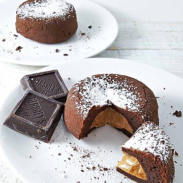 two peanut butter chocolate lava cakes on two plates.