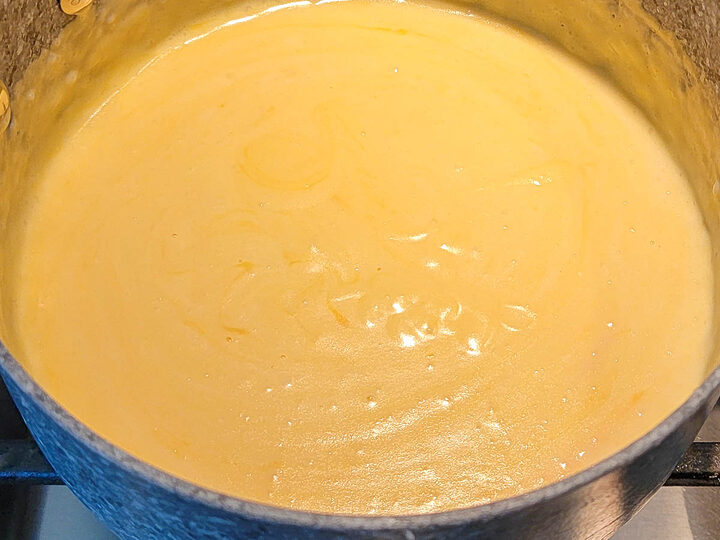 au gratin cheese sauce cooking in a pan.