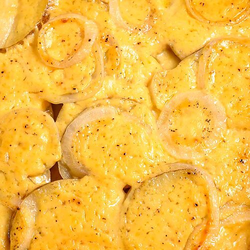au gratin potatoes and onions in a baking dish.