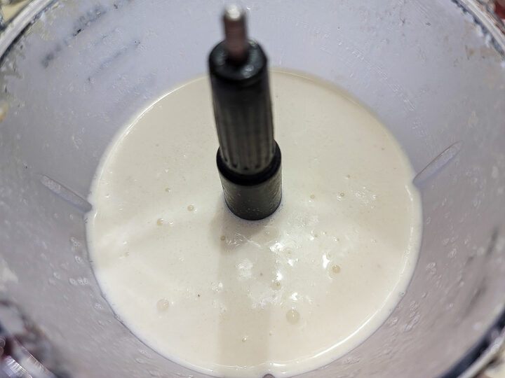 frozen bananas, coconut rum, coconut cream, ice cubes, and pineapple juice mixed in a blender.