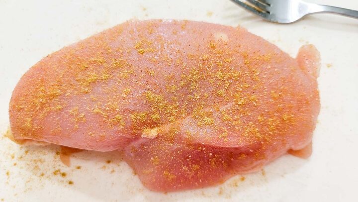raw chicken seasoned with cumin and seasoned salt.