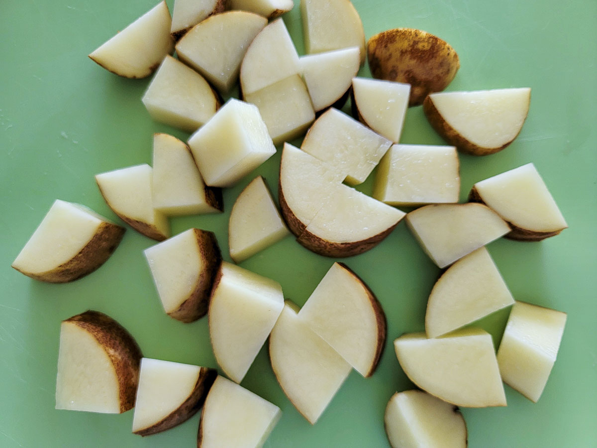 cubed potatoes on a cutting board.