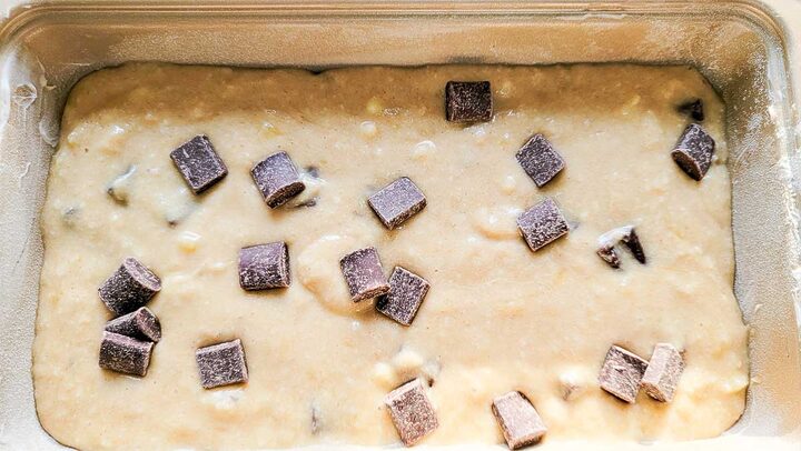 chocolate chunk banana bread batter in a loaf pan.