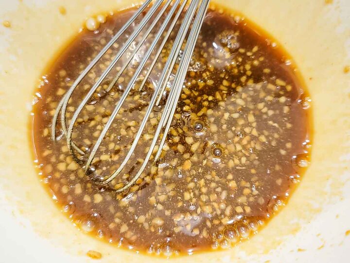 maple syrup, soy sauce, Dijon, and garlic whisked in a bowl.